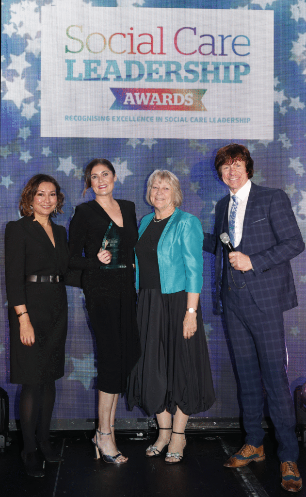 A group of people on stage at an award presentation