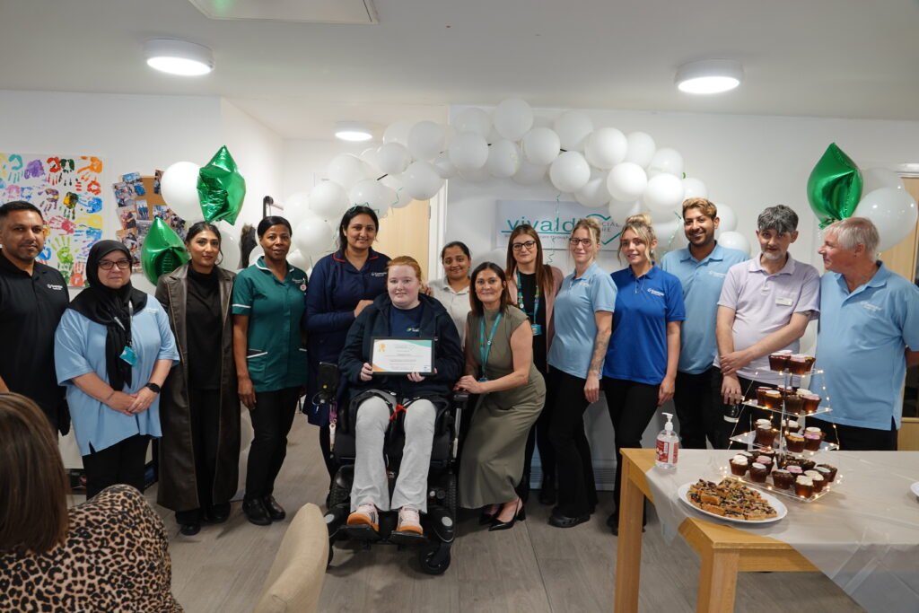 A group of people holding up a certificate